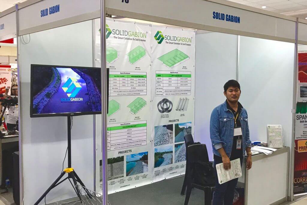 A man stands at the Solid Gabion trade show booth.