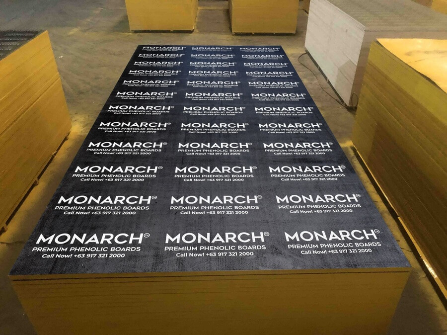 Stacks of Monarch Premium Phenolic Boards, showing branding and contact info.