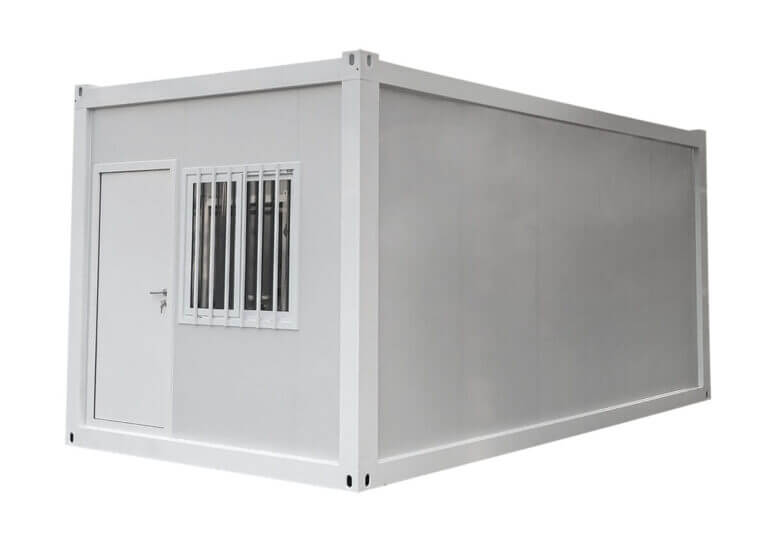 A white, prefabricated container with a door and barred window.