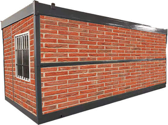 Brick-clad shipping container with a barred window, viewed at an angle.