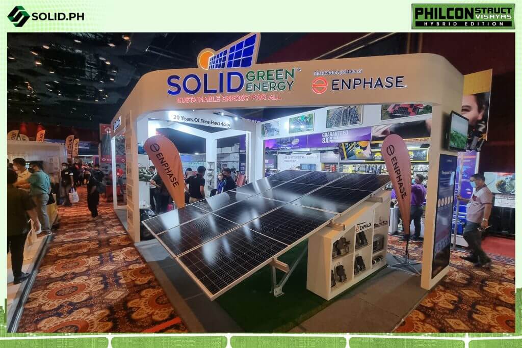 Solid Green Energy booth featuring solar panels at an expo.