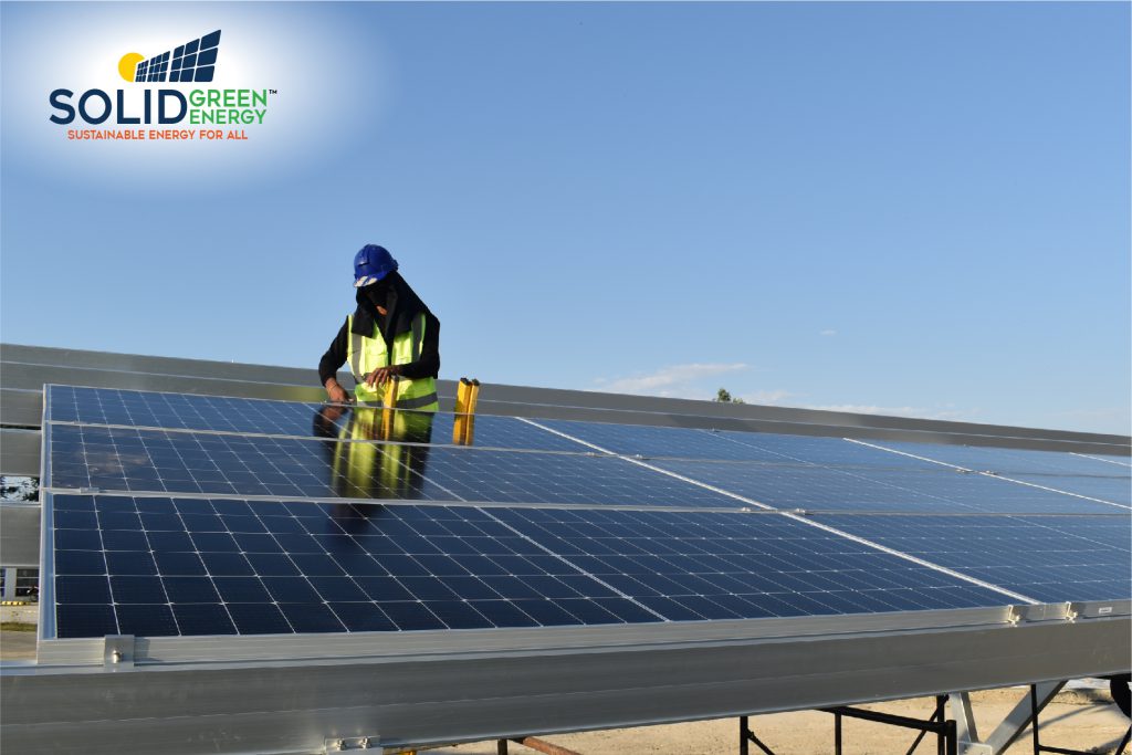 SolidGreen Energy staff installing the Solar PV panels